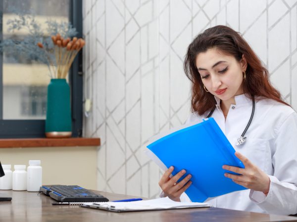 Young doctor checking patient's analysis. High quality photo
